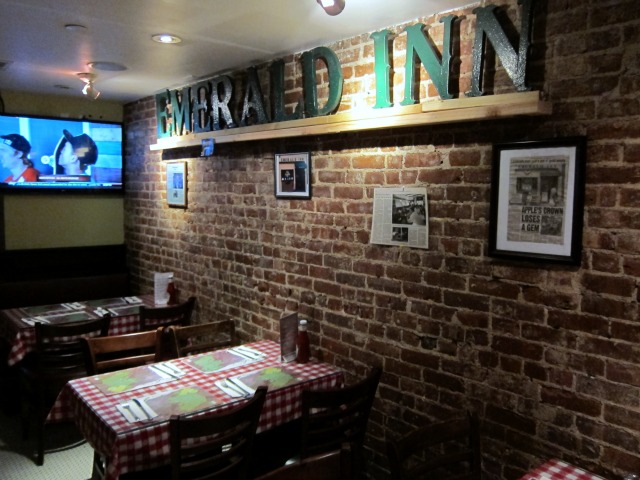 The interior of The Emerald Inn's new location on the Upper West Side. Here the Emerald Inn's old signage is hanging on the wall above some of the originals booths