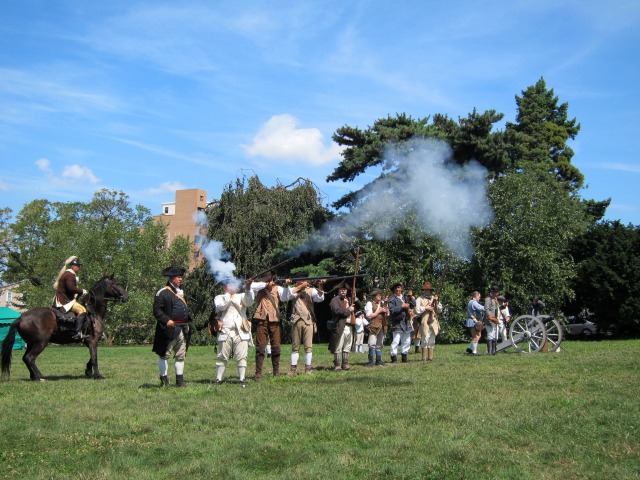 Image of the Revolutionary War reactors shooting their guns into the air at the Green-Wood Cemetery 