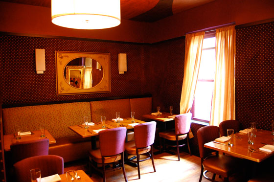 The interior seating at Vegetarian restaurant Candle 79, colored red and white