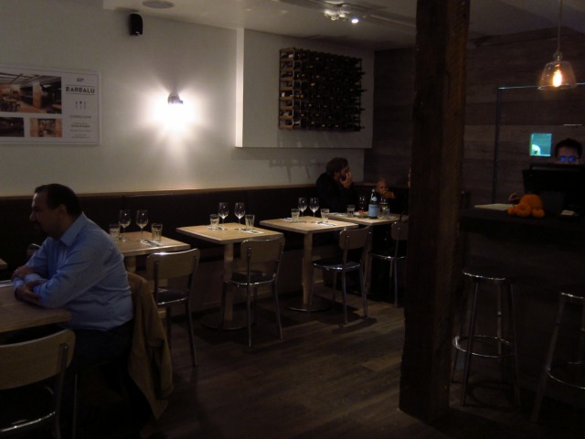 Restaurant patrons enjoying italian food in the dimly lit seating area of Barbalu