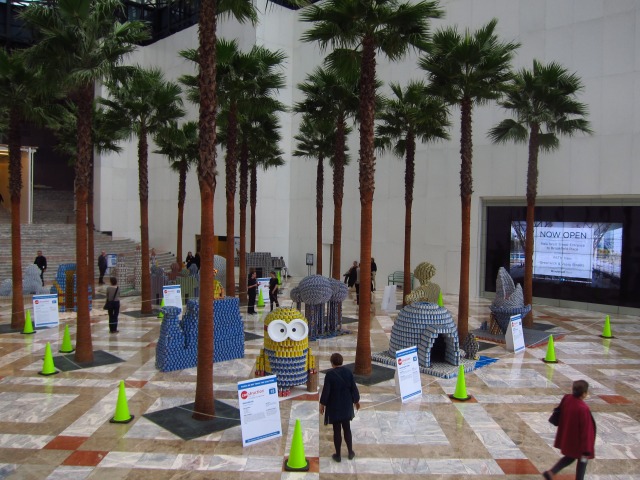 Palm trees tower high over the Canstruction entries on display at Battery Park City's Winter Garden.