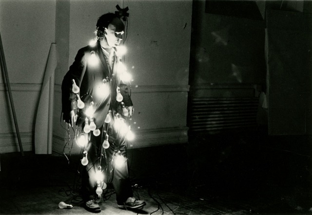 Jared Bark's piece at the Whitney of a manikin wearing a suit and strings of lit light bulbs  