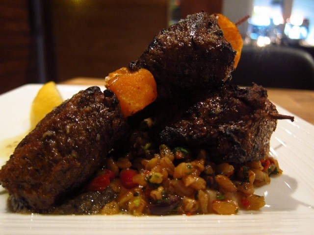 Image of the Snack EOS lamb from the Kalamaki section of the menu, accompanied with chunks of soft, sweet squash and chewy farro salad.