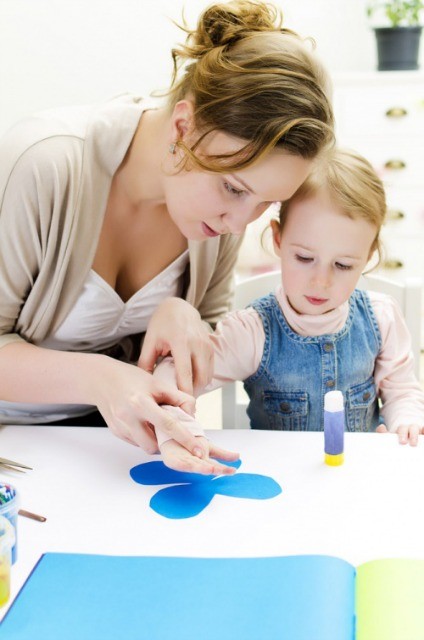 A toddler and an art instructor working on an art project at the Art Center in NYC