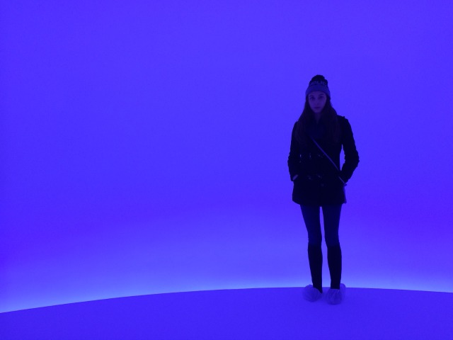 Young women standing in the blue light of Doug Wheeler's Infinity installation at David Zwirner Gallery