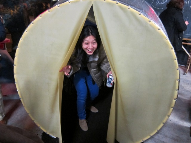 Young women inside one of The Last Brucennial's pieces of artwork that resembles a round tent