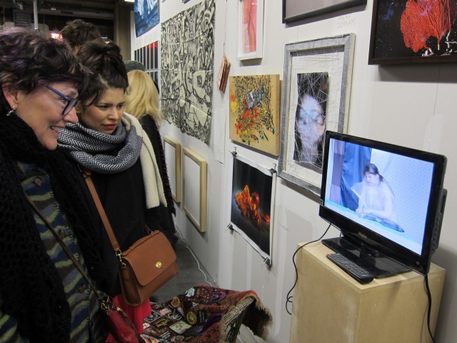 Two women watching one of the video artworks on display at The Last Brucennial in NYC