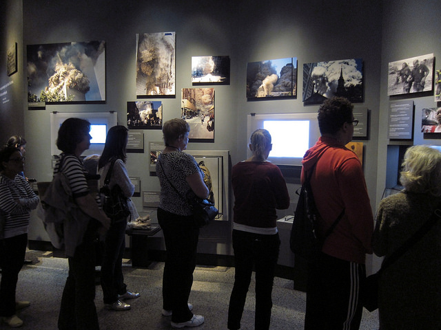 Visitors quietly watch videos and images of the 9/11 attacks inside the 9/11 Memorial Museum.