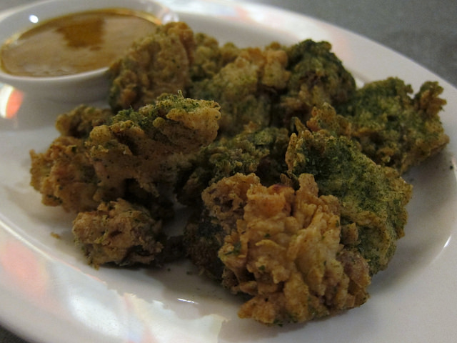 A plate of JFC "double-dredged" fried chicken hearts and livers with a side of honey mustard.