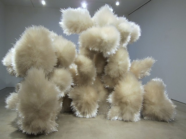 Image of Tara Donovan's sculpture create out of acrylic rods, which makes it look like a fuzzy balls or an exploding galaxy.