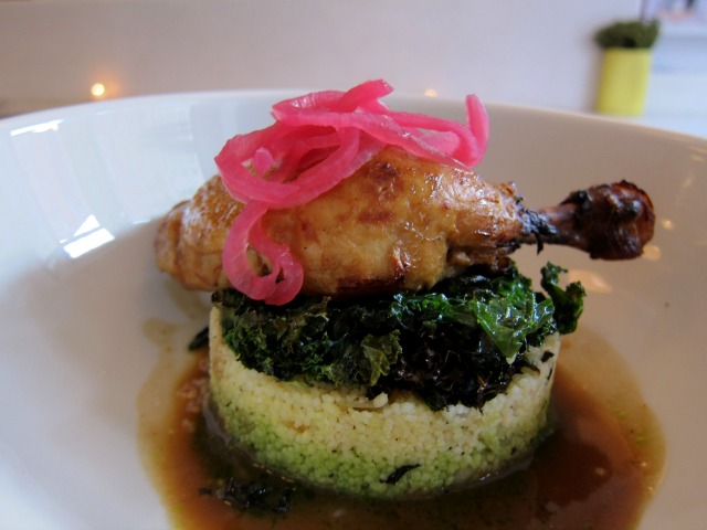 Juicy braised chicken served over kale salad and apricot couscous. 