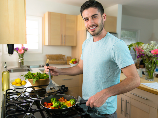 single man cooking a nutritious meal at home