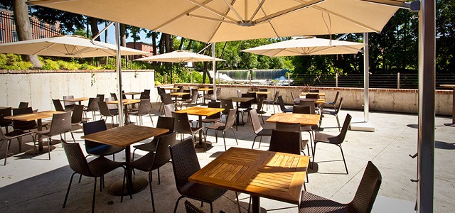 A view of the Roundhouse patio bar and outdoor seating area with Beacon Falls in the background.