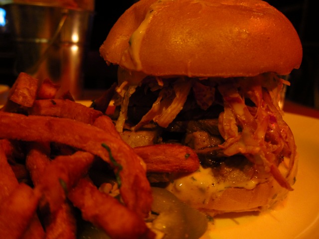 Image of the Route 66 Smokehouse's Brisket sandwich with a side of sweet potato fries