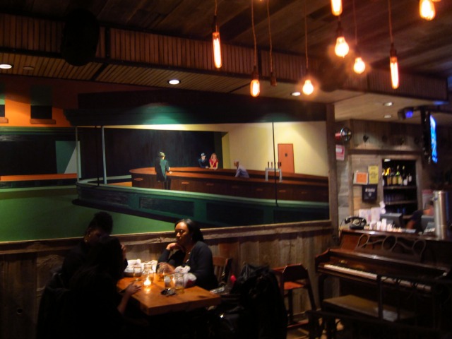 A painting hangs on the wall of the interior of Route 66 Smokehouse in downtown NYC