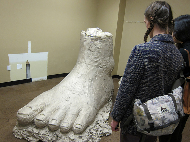 Two young girls standing at the Gagosian gallery for Urs Fisher's foot