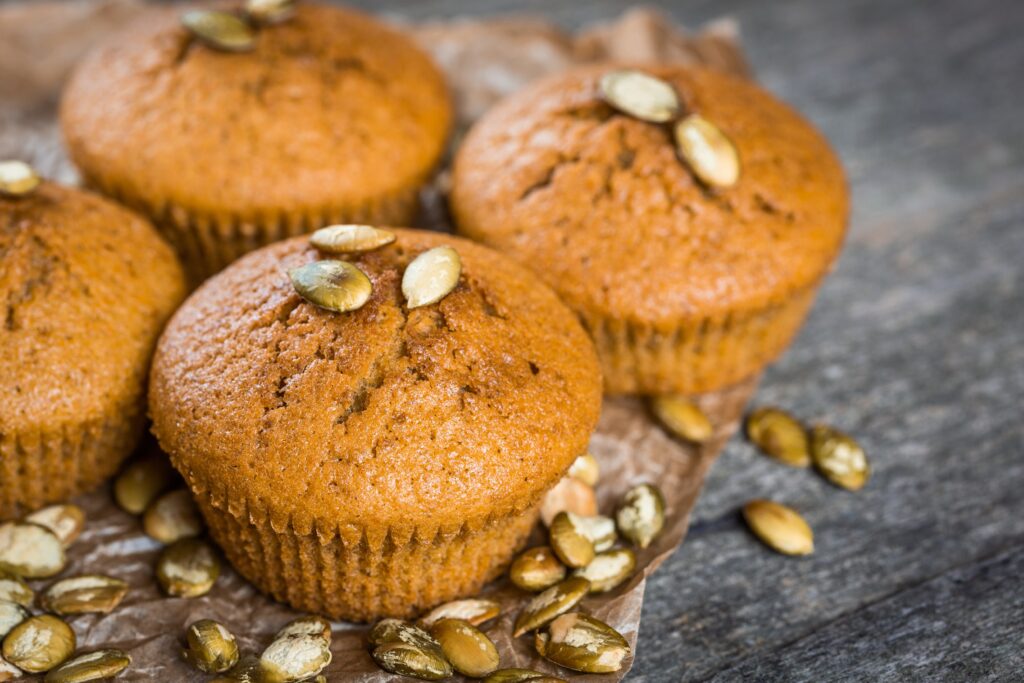 Pumpkin muffins on wooden background. Dietary product. Useful children's dessert. Bright. Seasonal product. Diet. Recipe